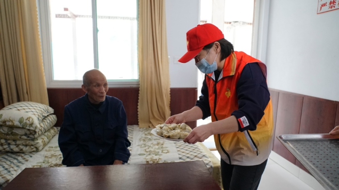为老人送上煮好的水饺